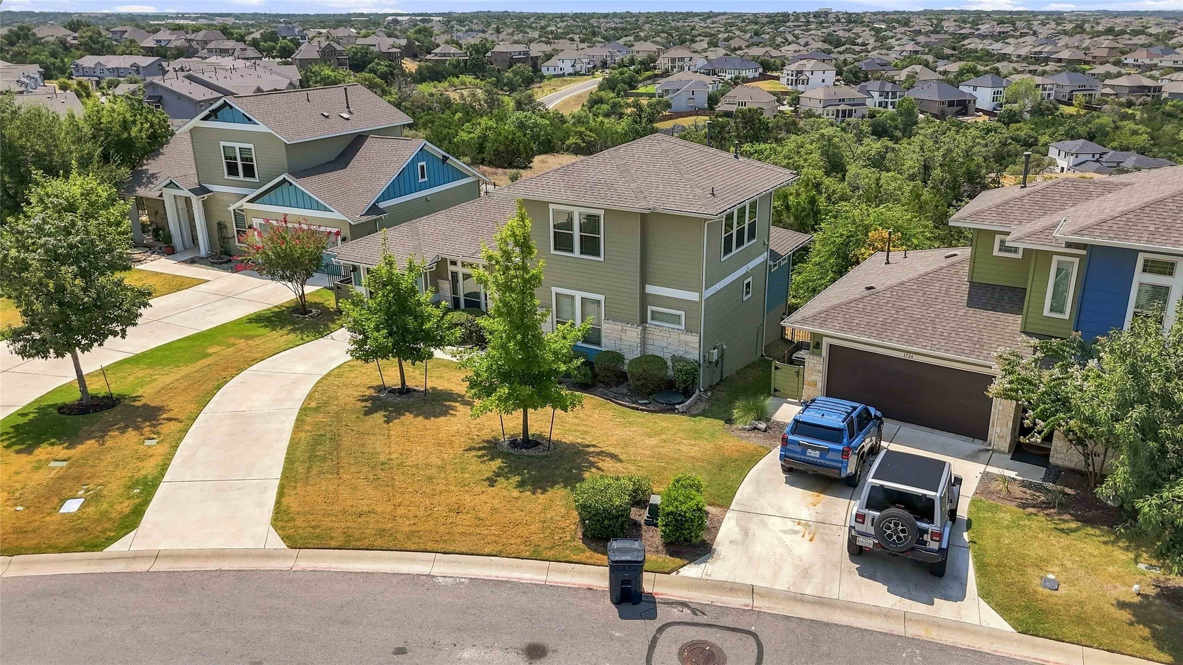1722 Rowdy Loop, Unit 7 Leander, TX 78641 - Photo 26 of 37 Nestled in a charming neighborhood, this modern home boasts well-maintained landscaping and a spacious driveway. Surrounded by lush greenery, it offers a serene suburban setting with easy access to community amenities.