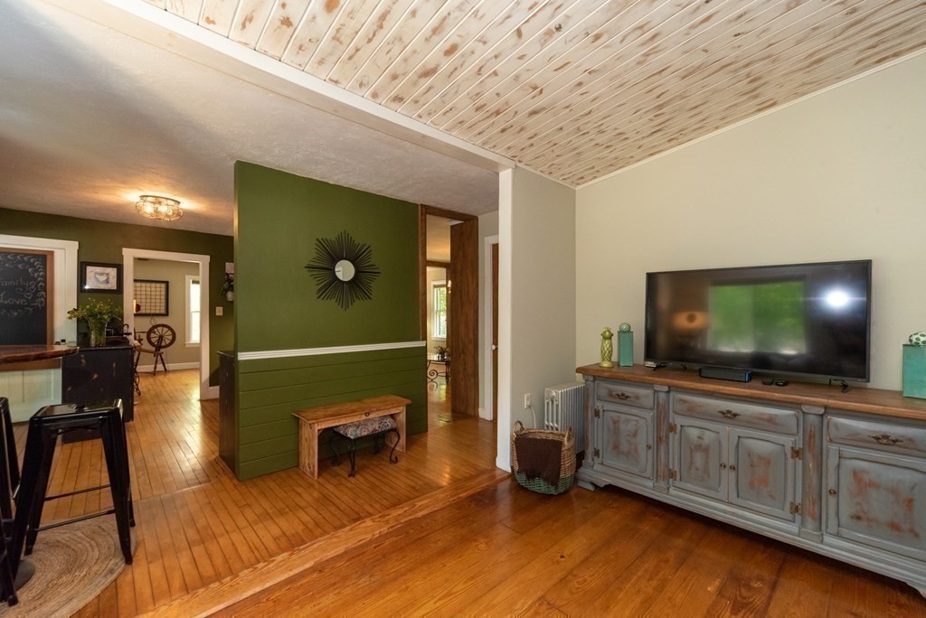 1423 Piper Road Ashby, MA 01431 - Photo 11 of 42 a living room with furniture and a flat screen tv