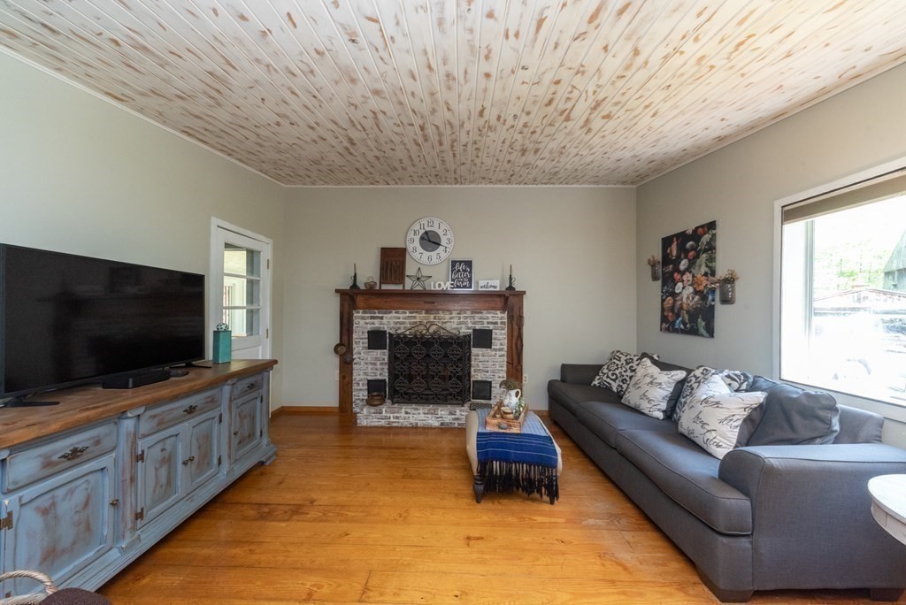 1423 Piper Road Ashby, MA 01431 - Photo 13 of 42 a living room with furniture and a flat screen tv