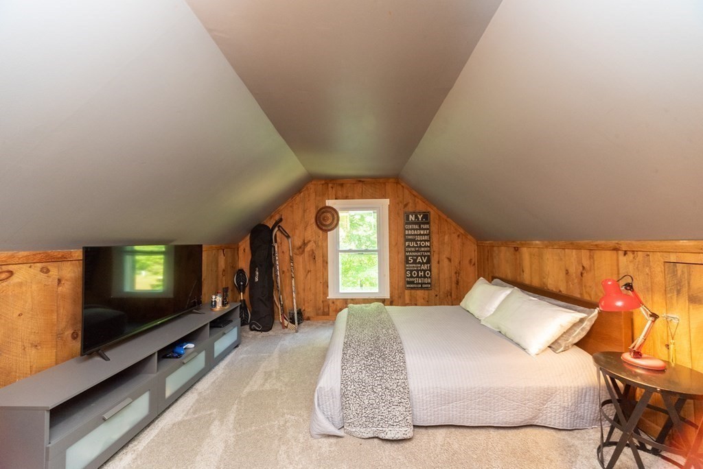 1423 Piper Road Ashby, MA 01431 - Photo 25 of 42 a bedroom with a bed and a flat tv screen on dresser