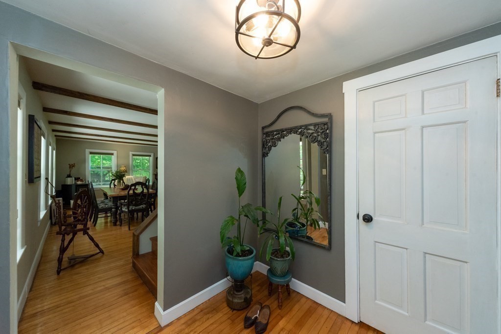 1423 Piper Road Ashby, MA 01431 - Photo 5 of 42 a view of a hallway with wooden floor and a potted plant