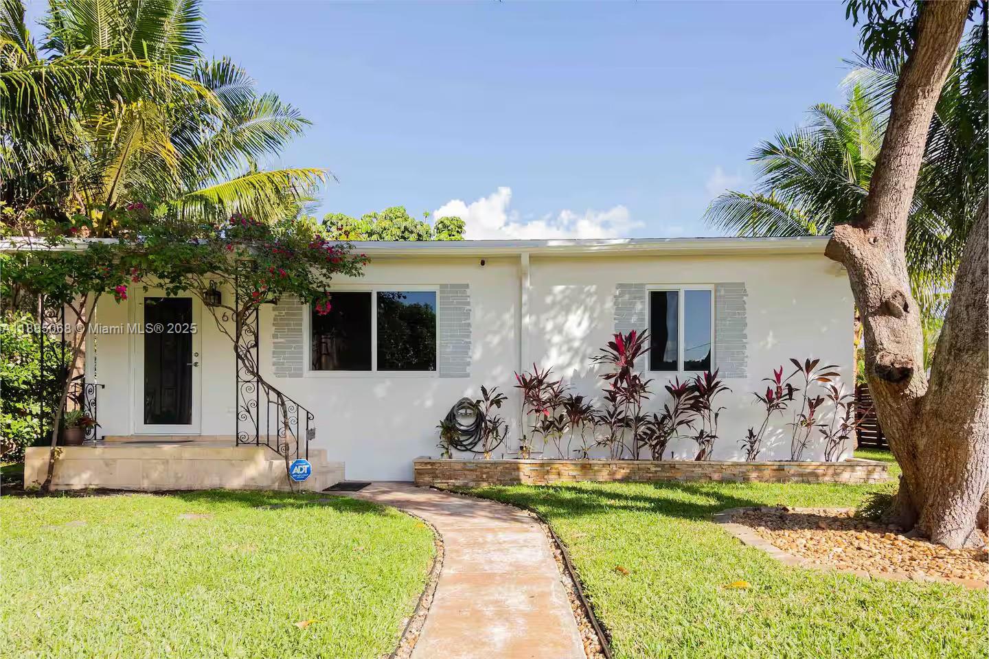 a view of a house with swimming pool and sitting area