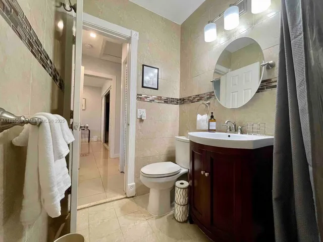 a bathroom with a toilet sink and mirror