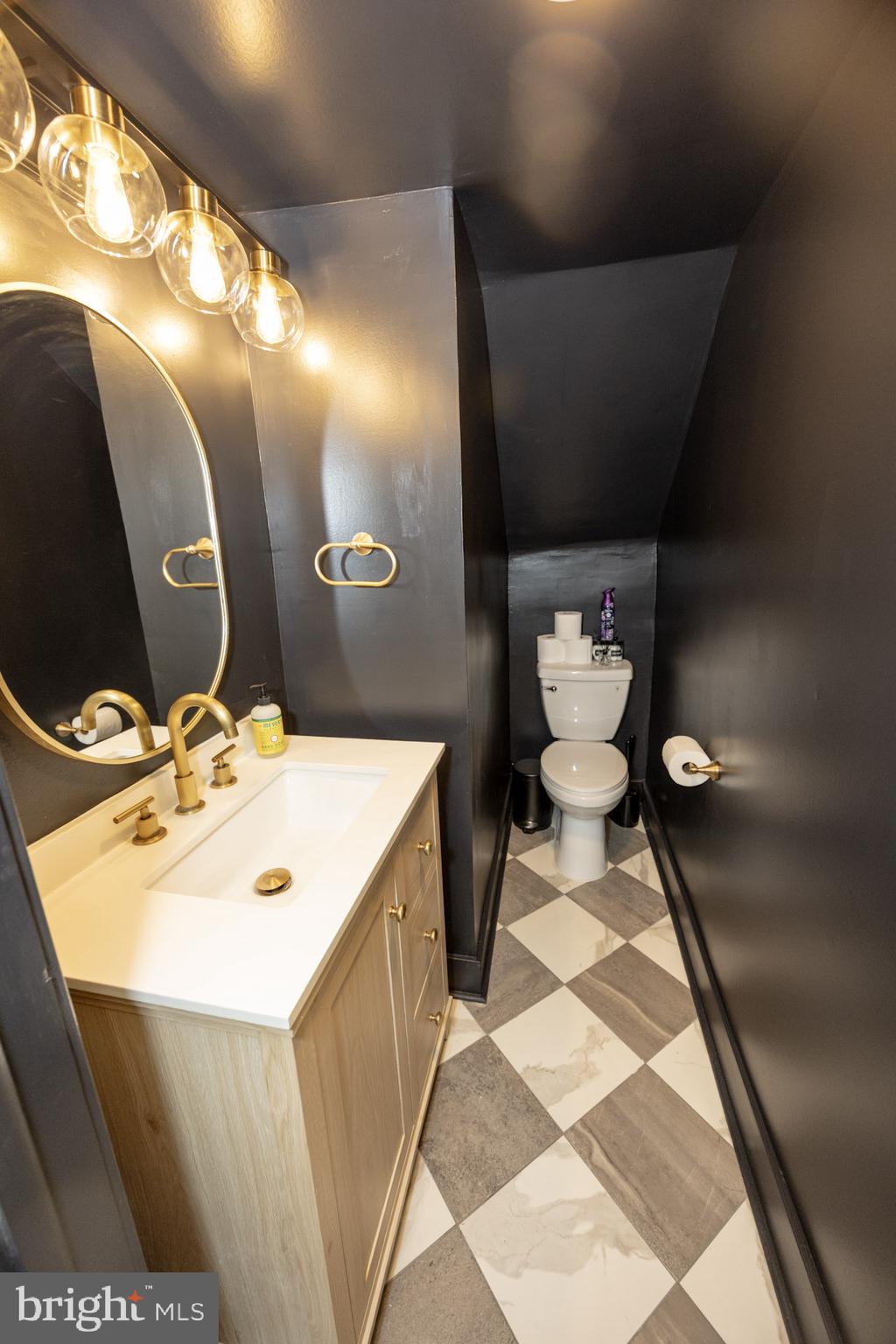 411 Vernon Road Philadelphia, PA 19119 - Photo 16 of 49 a bathroom with a sink and mirror with toilet