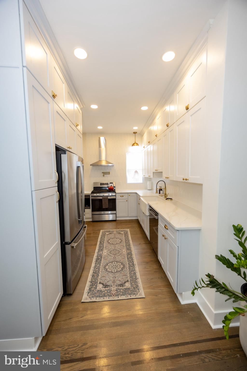 411 Vernon Road Philadelphia, PA 19119 - Photo 18 of 49 a large kitchen with a sink stainless steel appliances and a counter top space