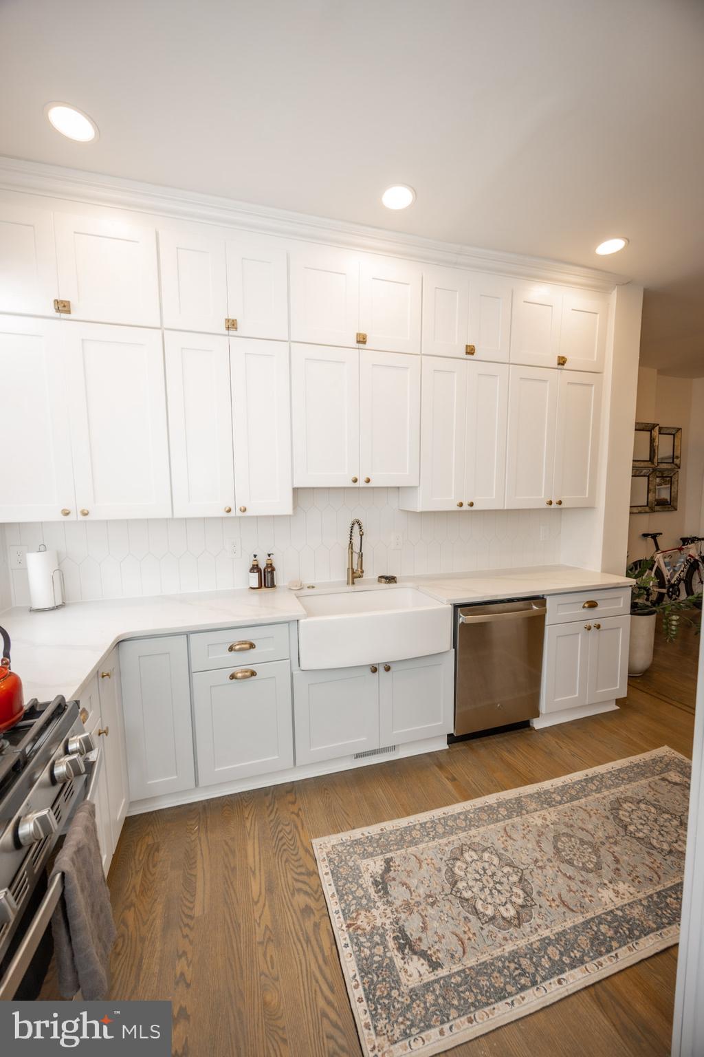 411 Vernon Road Philadelphia, PA 19119 - Photo 22 of 49 a large white kitchen with kitchen island a sink stainless steel appliances and cabinets