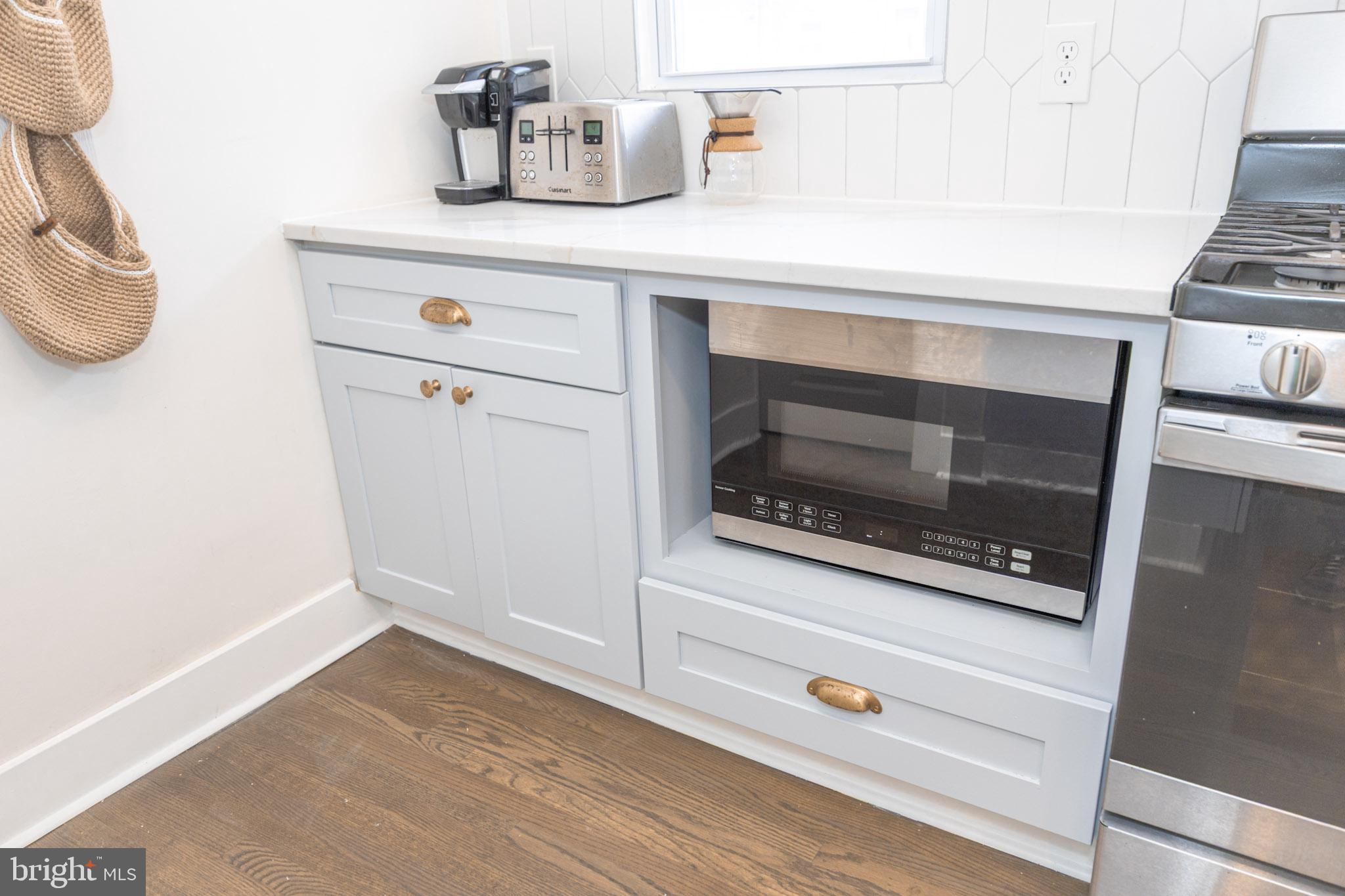 411 Vernon Road Philadelphia, PA 19119 - Photo 24 of 49 a kitchen with a stove and a white cabinet