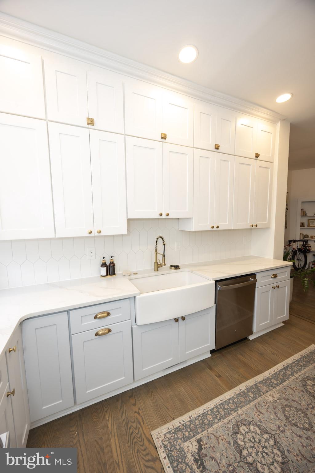 411 Vernon Road Philadelphia, PA 19119 - Photo 26 of 49 a large white kitchen with a sink a window and stainless steel appliances