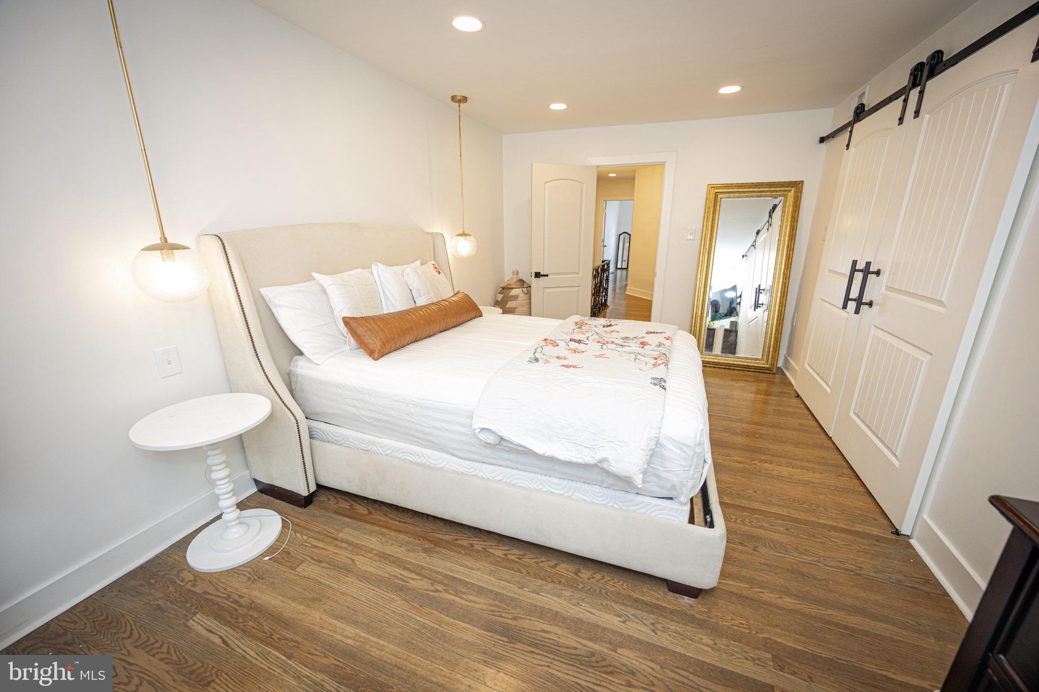 411 Vernon Road Philadelphia, PA 19119 - Photo 34 of 49 a bedroom with a bed and a wooden floor