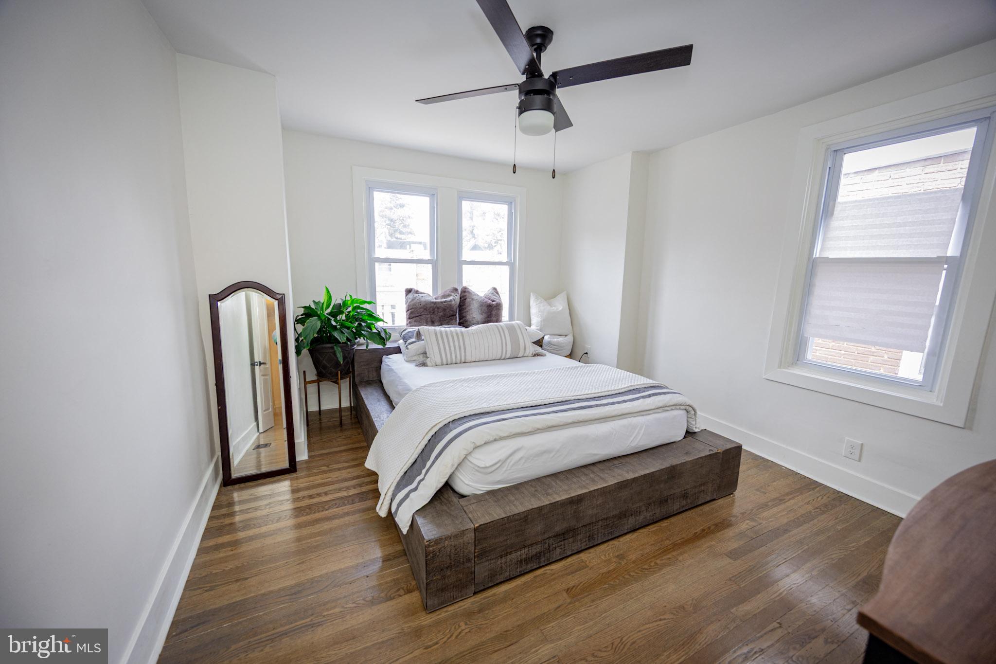411 Vernon Road Philadelphia, PA 19119 - Photo 39 of 49 a bedroom with a bed chair and wooden floor