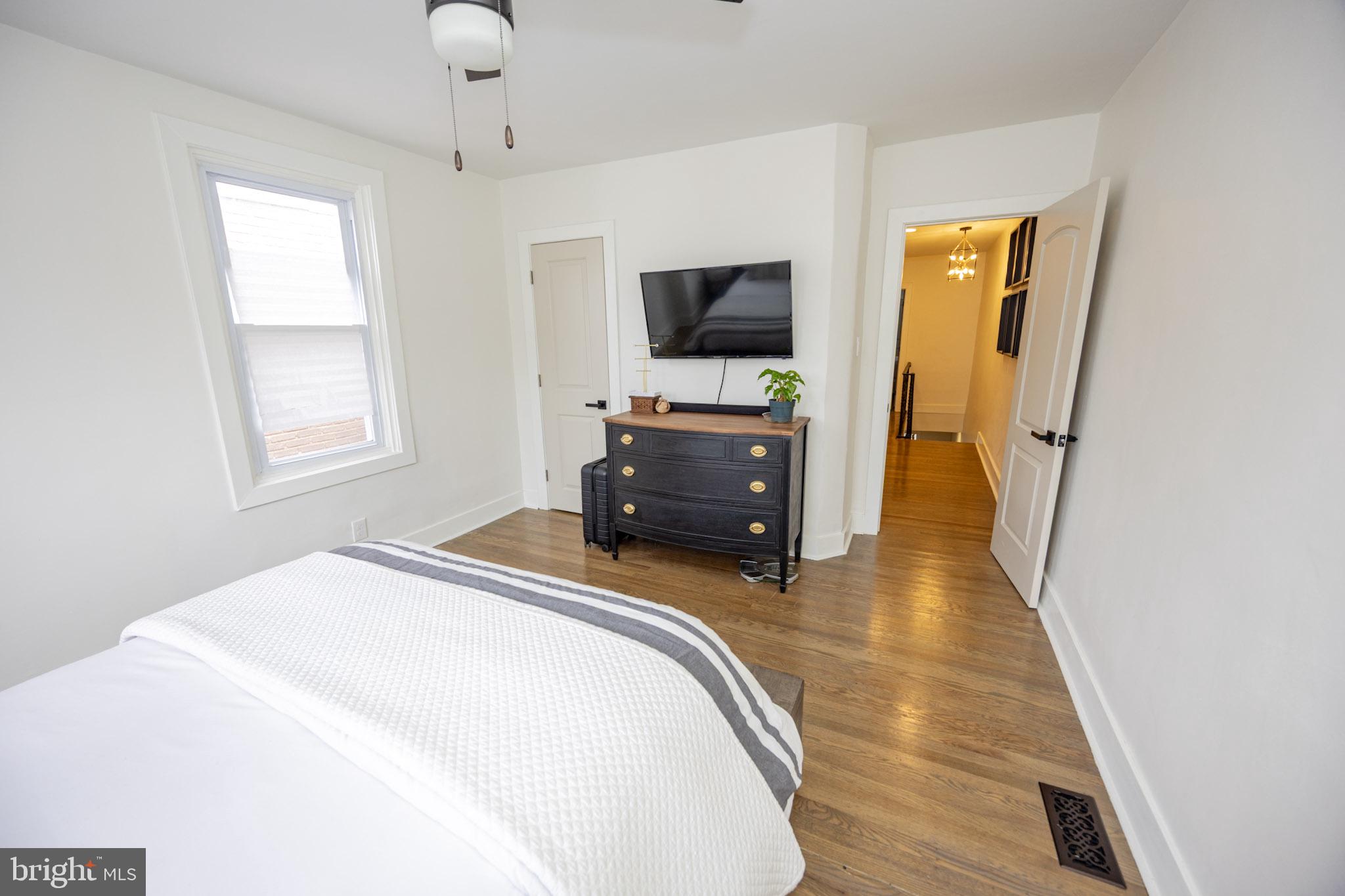 411 Vernon Road Philadelphia, PA 19119 - Photo 40 of 49 a bedroom with a bed and a flat tv screen on dresser