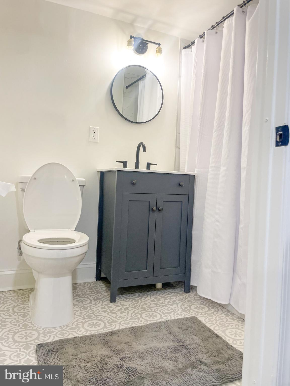 411 Vernon Road Philadelphia, PA 19119 - Photo 43 of 49 a bathroom with a toilet a sink and mirror
