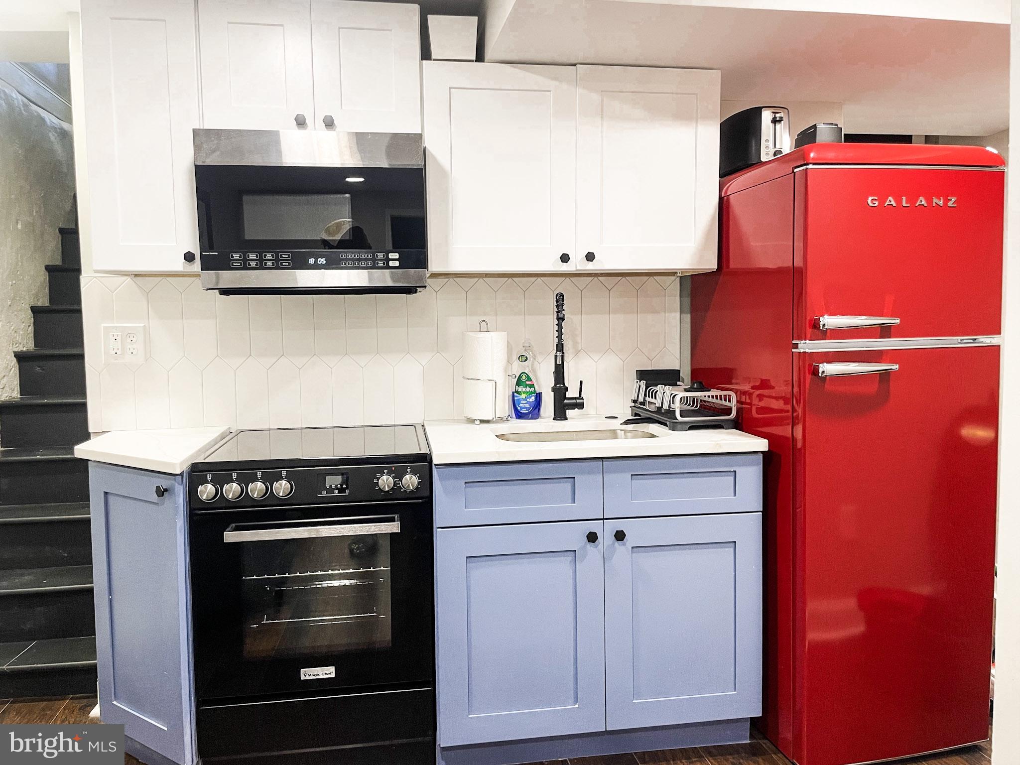 411 Vernon Road Philadelphia, PA 19119 - Photo 45 of 49 a kitchen with stainless steel appliances a stove and a microwave