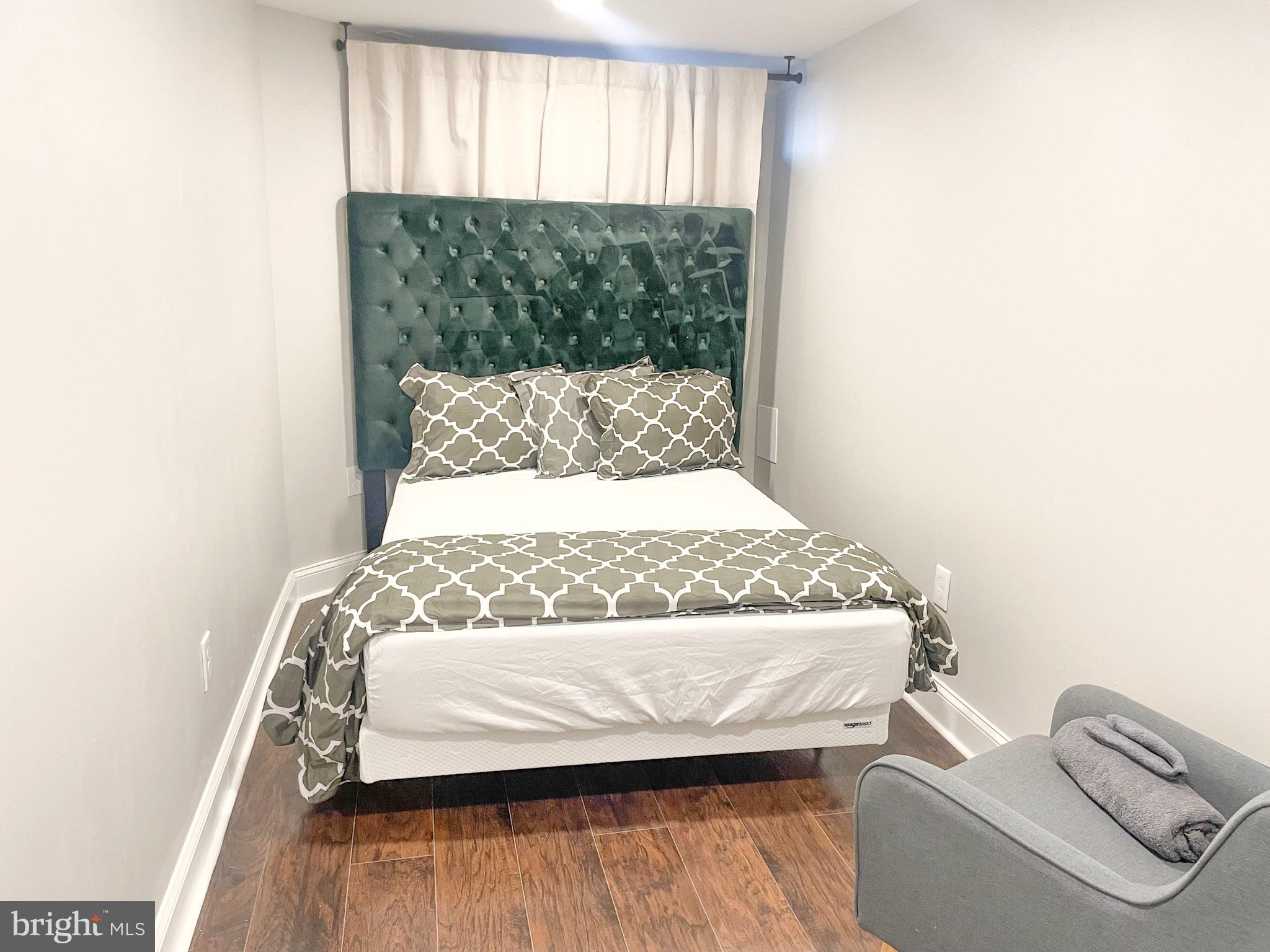 411 Vernon Road Philadelphia, PA 19119 - Photo 46 of 49 a bed sitting in a bedroom next to a window