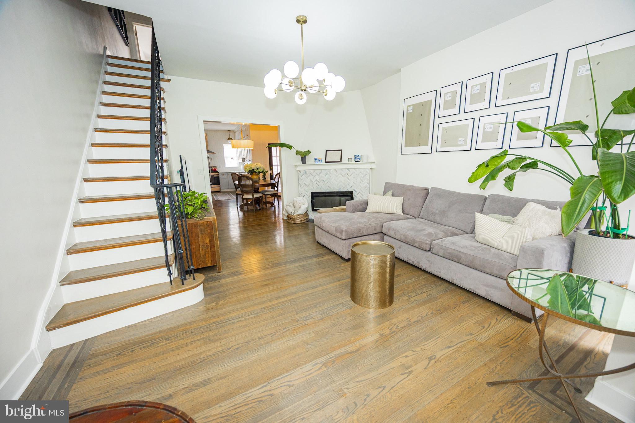 411 Vernon Road Philadelphia, PA 19119 - Photo 6 of 49 a living room with fireplace furniture and a chandelier