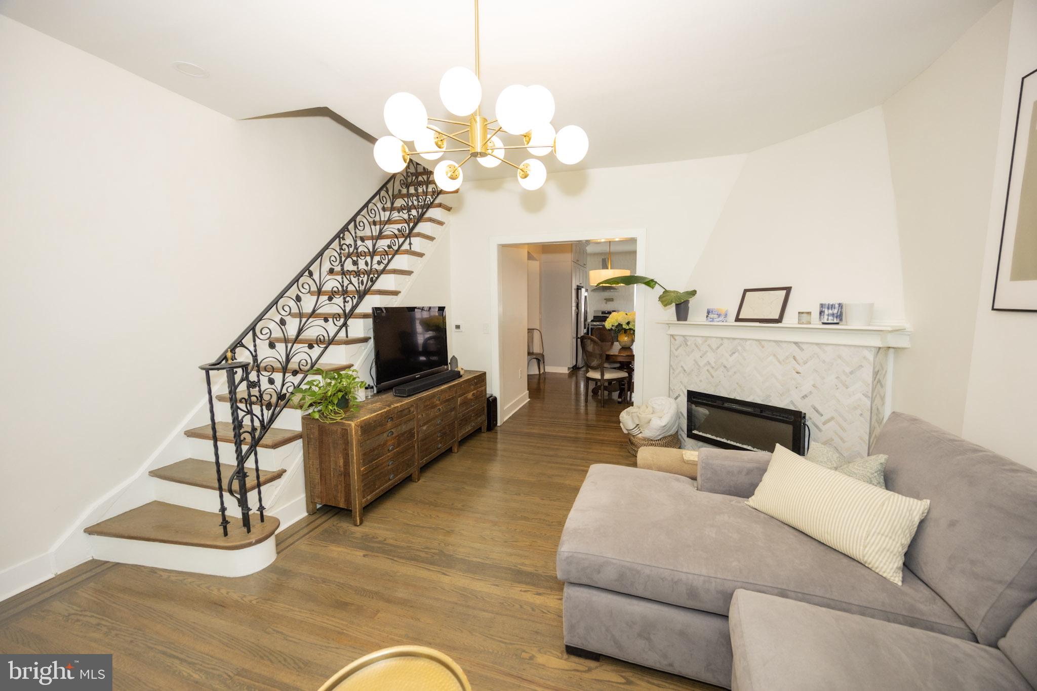 411 Vernon Road Philadelphia, PA 19119 - Photo 7 of 49 a living room with furniture and a chandelier