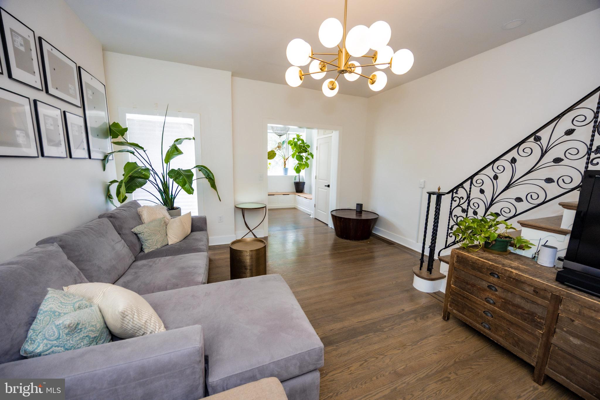 411 Vernon Road Philadelphia, PA 19119 - Photo 9 of 49 a living room with couches chandelier and a couch