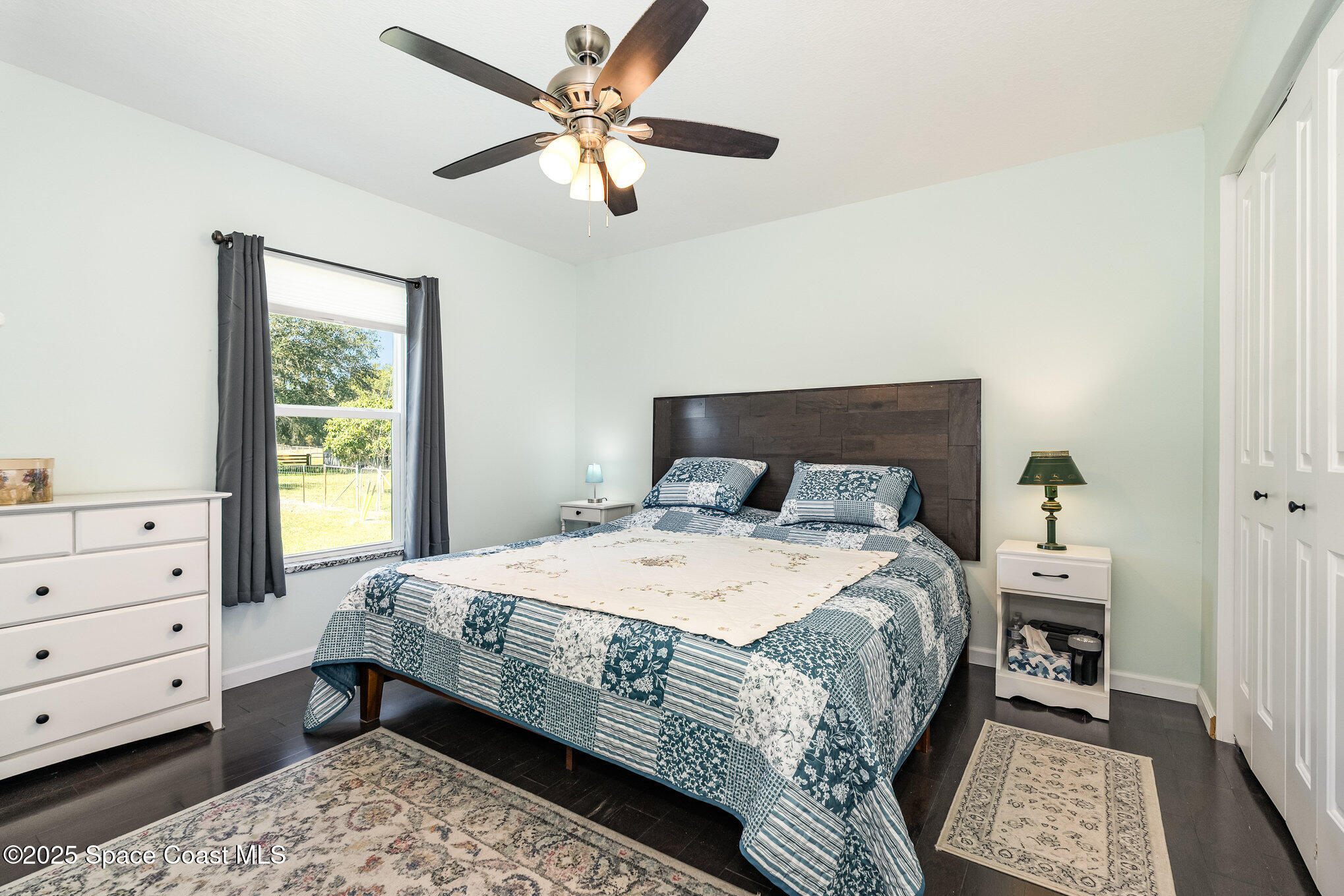 6786 U.S. Rte 1 Mims, FL 32754 - Photo 11 of 33 a bedroom with a bed a chandelier and a window