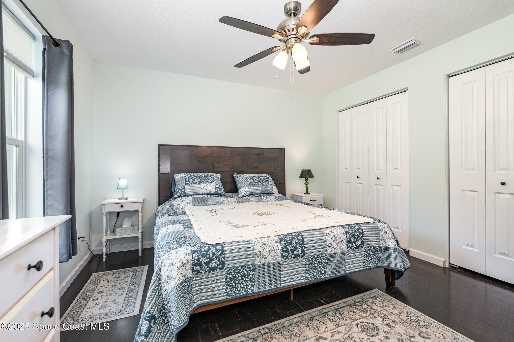 6786 U.S. Rte 1 Mims, FL 32754 - Photo 12 of 33 a bedroom with a bed a chandelier and a dresser