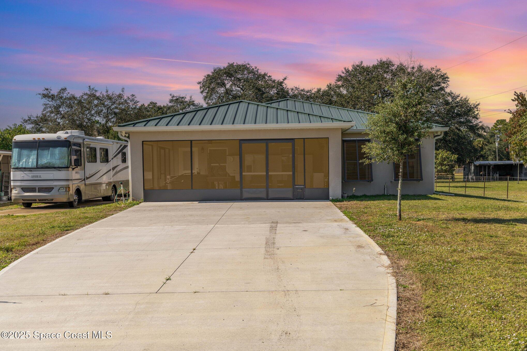 6786 U.S. Rte 1 Mims, FL 32754 - Photo 21 of 33 a front view of a house with a yard and garage