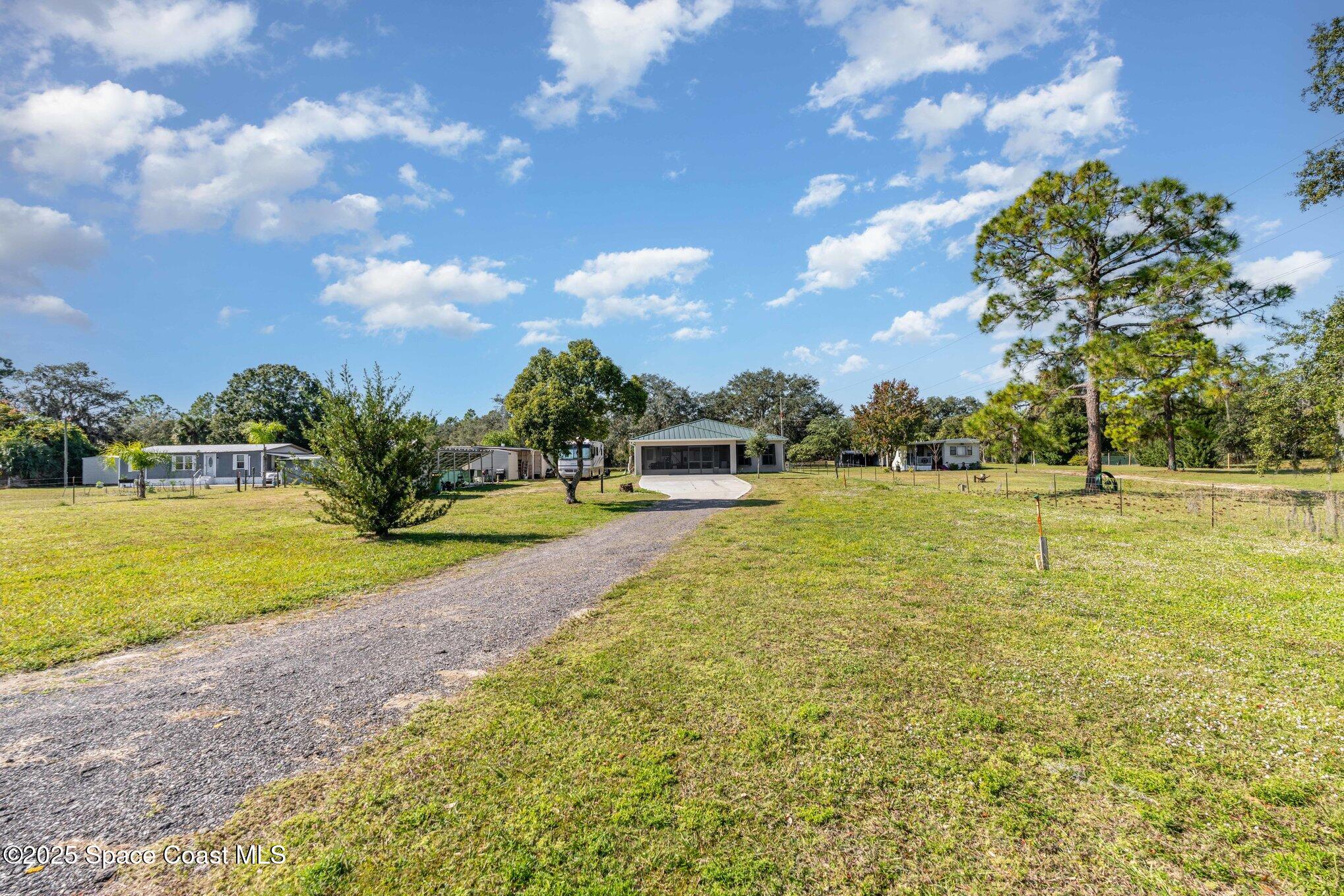 6786 U.S. Rte 1 Mims, FL 32754 - Photo 23 of 33 a view of a swimming pool with an outdoor seating and a garden