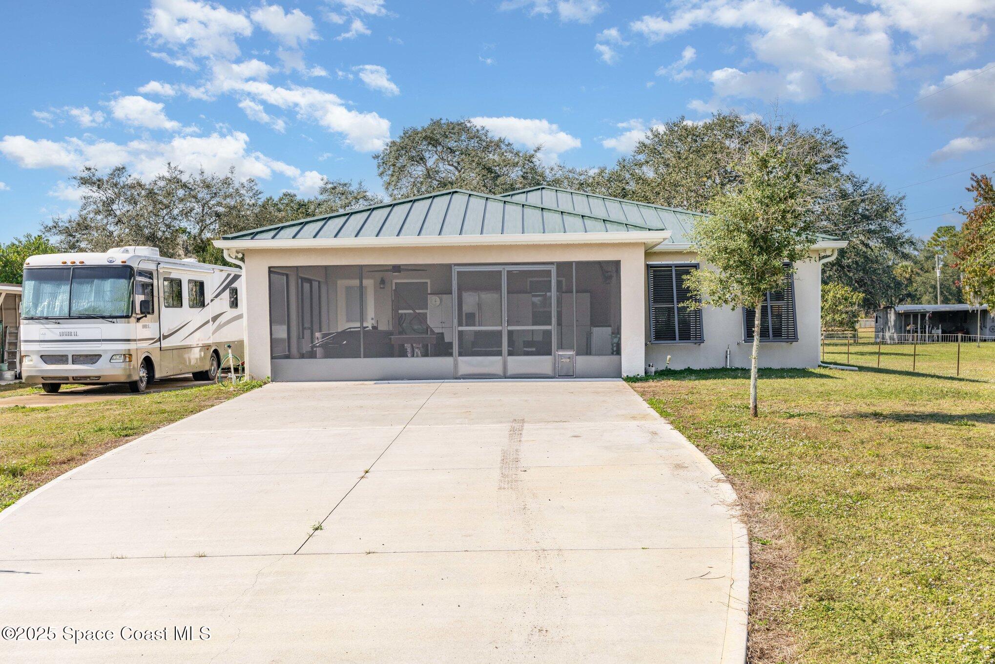 6786 U.S. Rte 1 Mims, FL 32754 - Photo 24 of 33 a view of white house with a garden and pathway