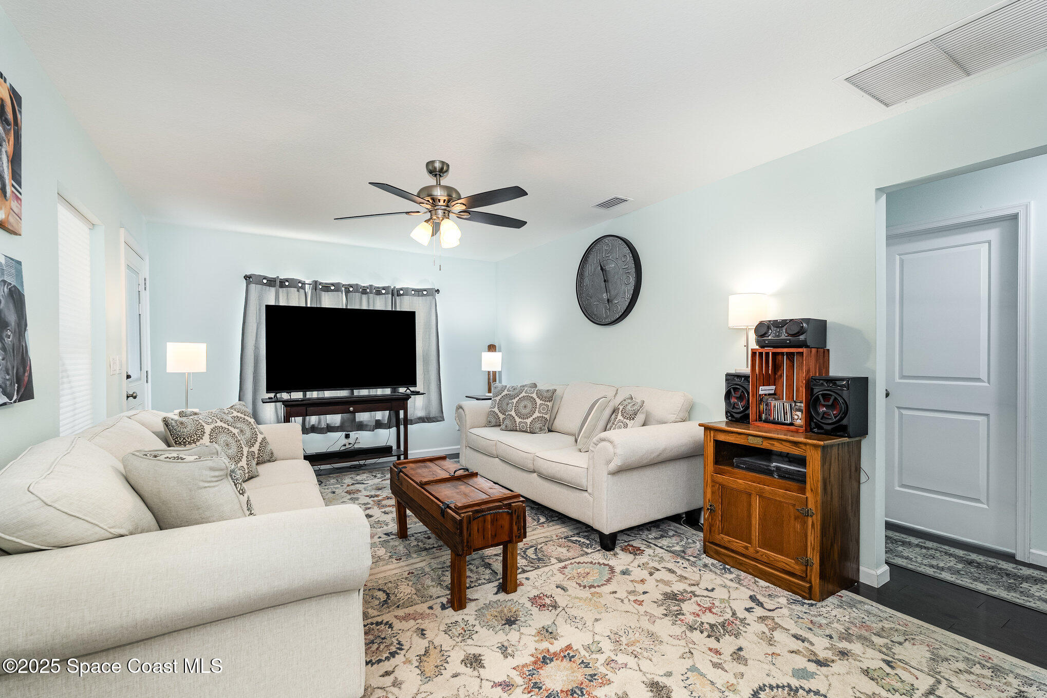 6786 U.S. Rte 1 Mims, FL 32754 - Photo 3 of 33 a living room with furniture a flat screen tv and a fireplace