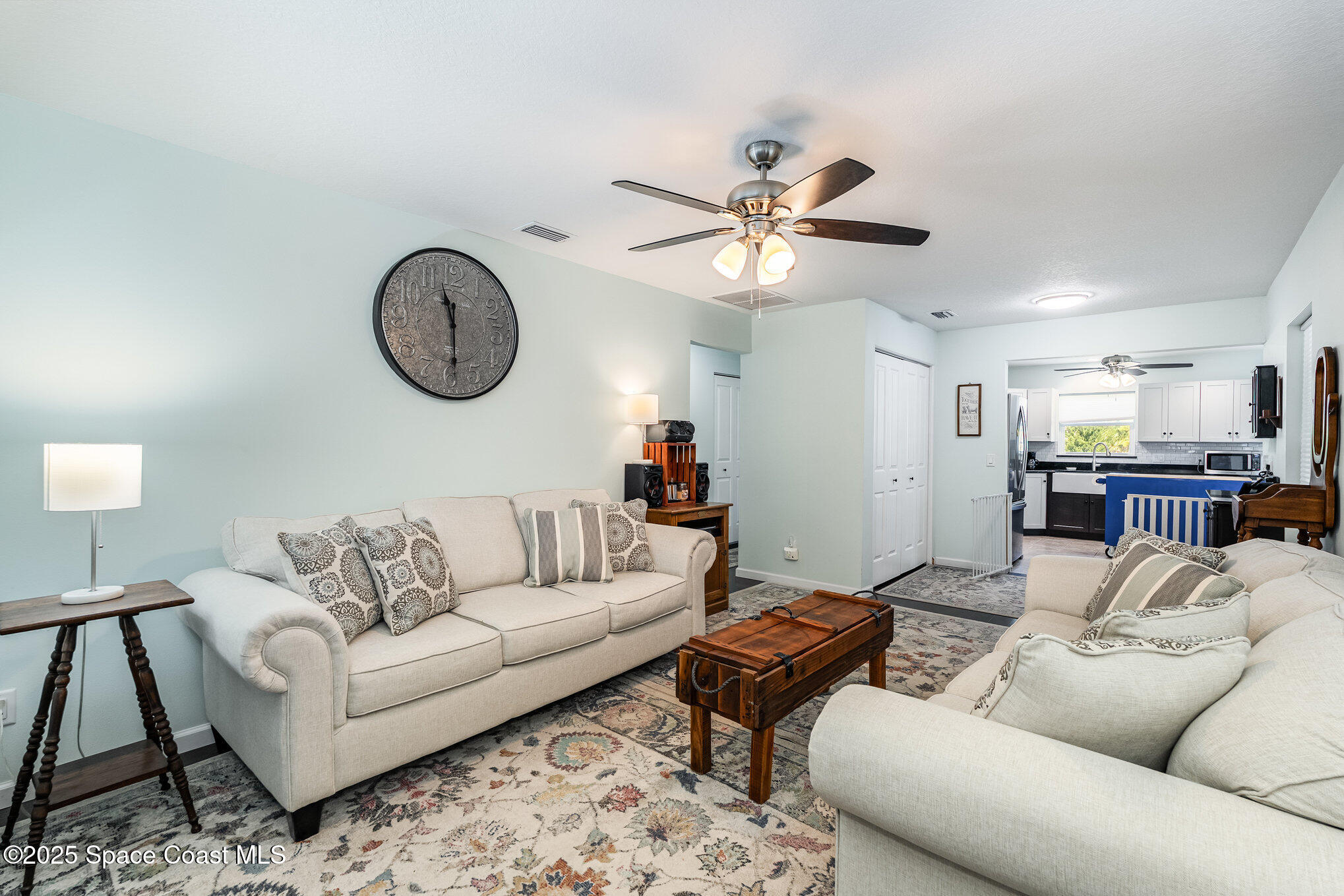 6786 U.S. Rte 1 Mims, FL 32754 - Photo 5 of 33 a living room with furniture a clock on wall and a window