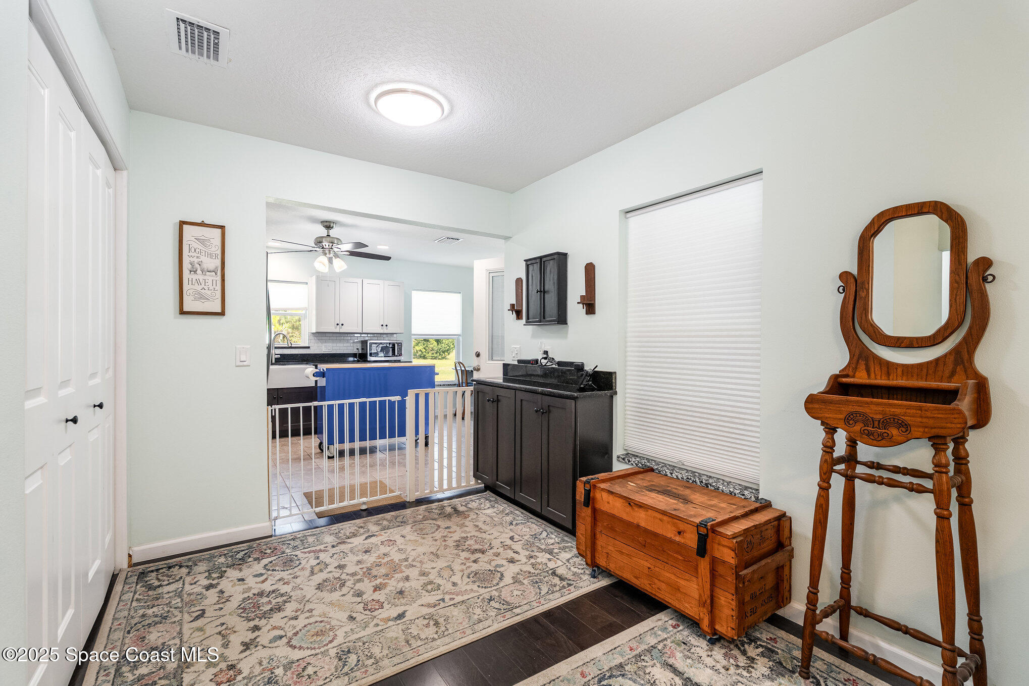 6786 U.S. Rte 1 Mims, FL 32754 - Photo 6 of 33 a living room with furniture a rug and a wooden floor