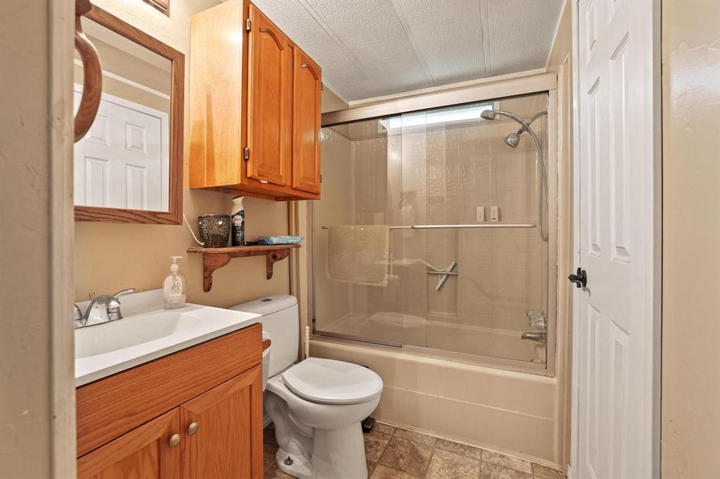 252 Meadow Lake Estates Road Denison, TX 75021 - Photo 12 of 37 Bathroom- shower/bath combo with built in cabinets.