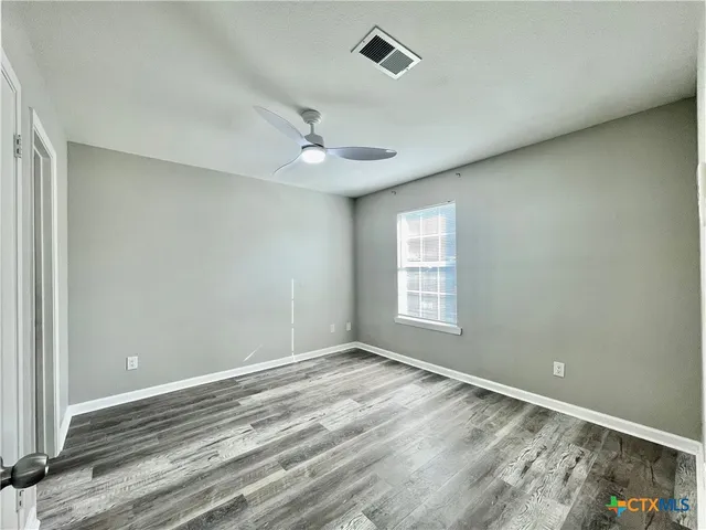 a view of room with window and ceiling fan