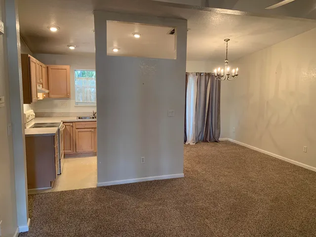 a view of a kitchen with a refrigerator a sink and a kitchen