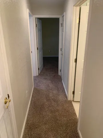 a kitchen with a refrigerator stove and white cabinets