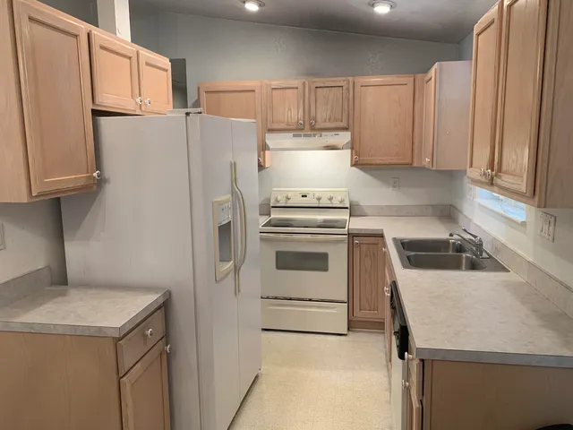 a kitchen that has a sink and a stove