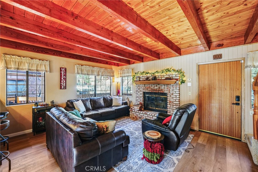 1847 Thrush Road Wrightwood, CA 92397 - Photo 3 of 33 a living room with furniture a fireplace and a large window