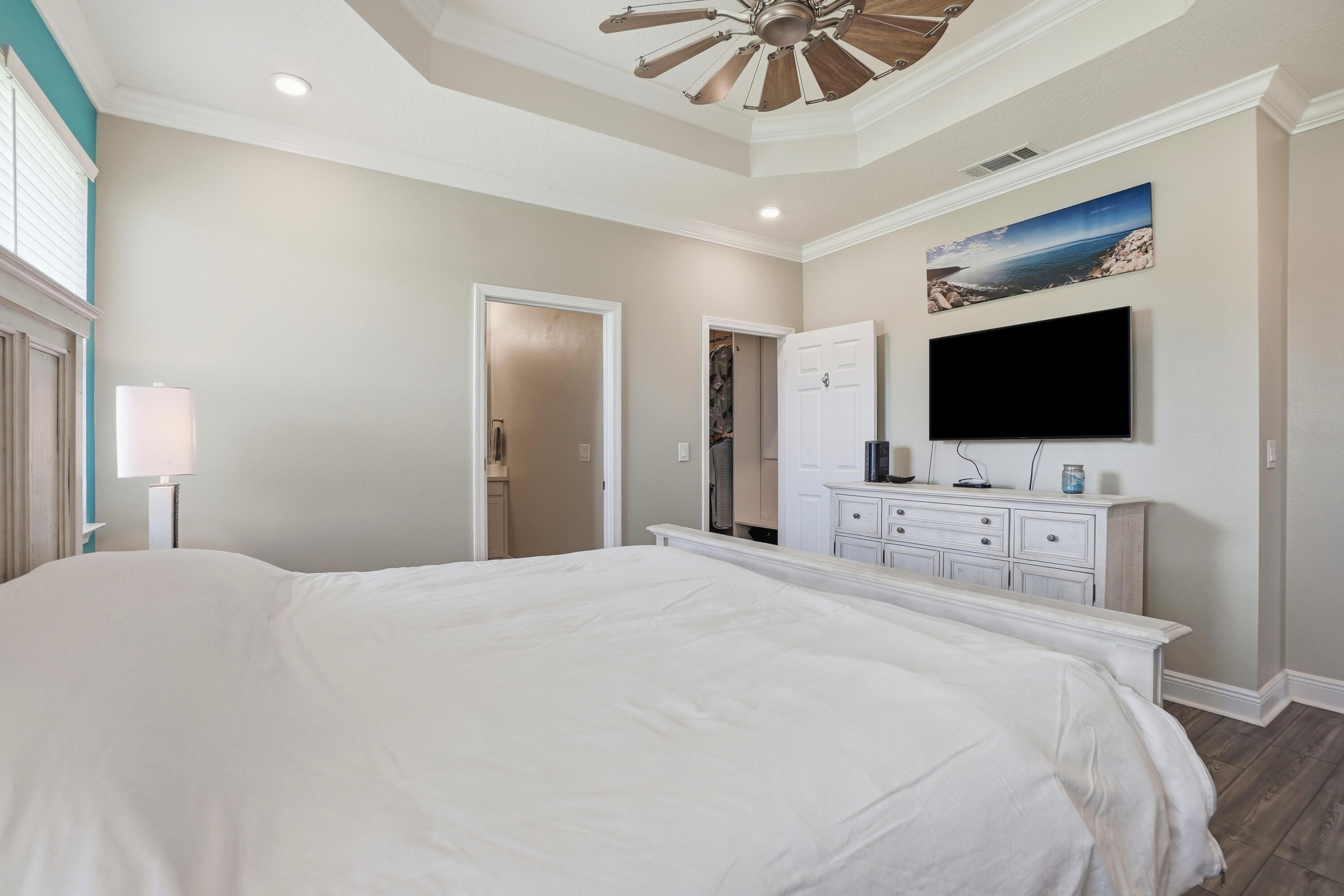 525 Windchime Way Freeport, FL 32439 - Photo 19 of 59 a bedroom with a bed tv and a chandelier