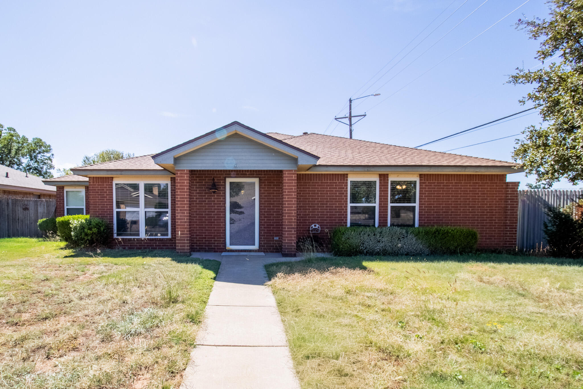 5731 95th Street Lubbock, TX 79424 - Photo 1 of 15 a front view of a house with garden
