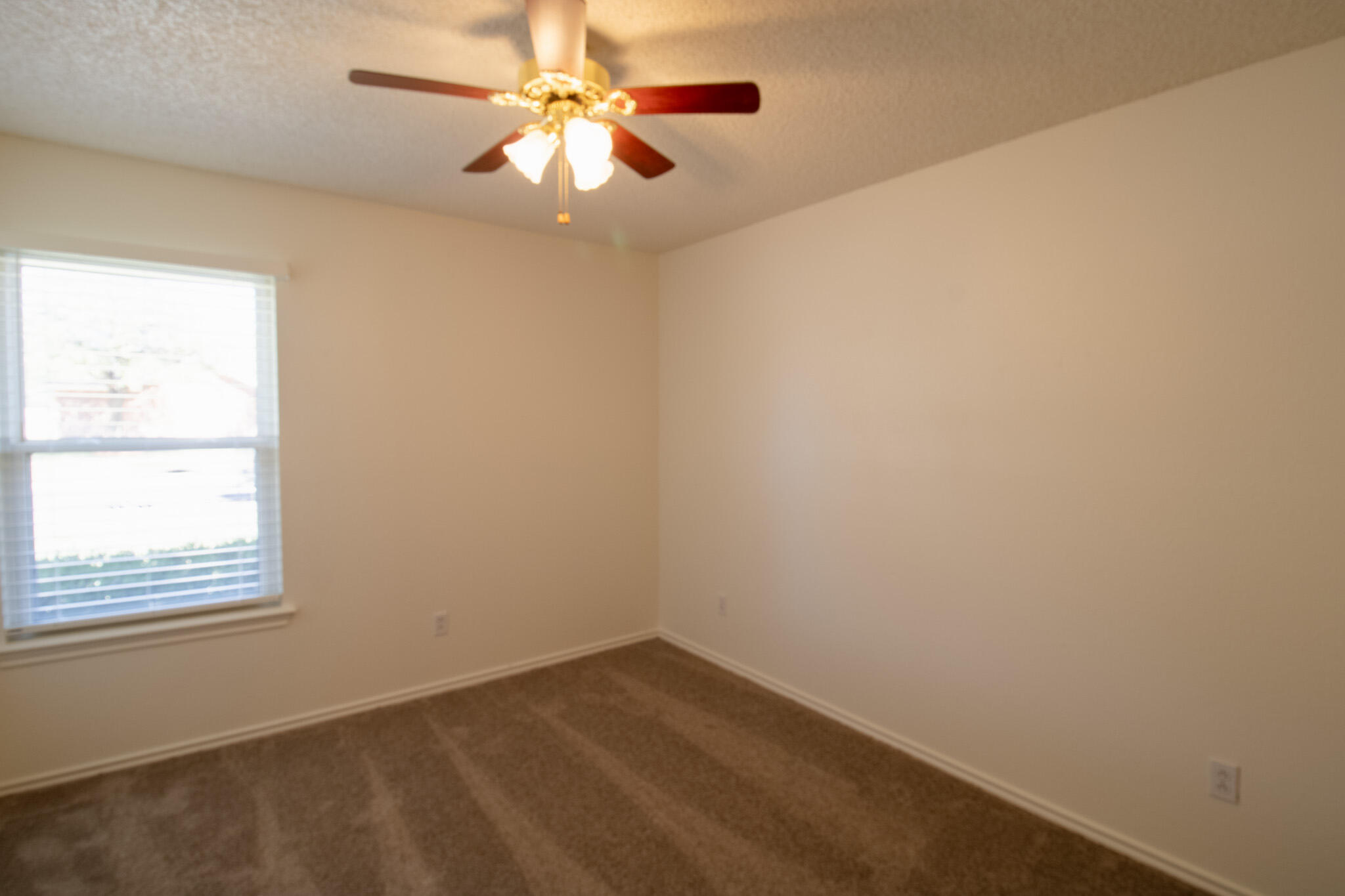 5731 95th Street Lubbock, TX 79424 - Photo 12 of 15 an empty room with a window and a fan