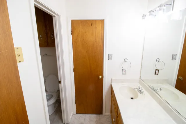 a bathroom with a tub sink and mirror