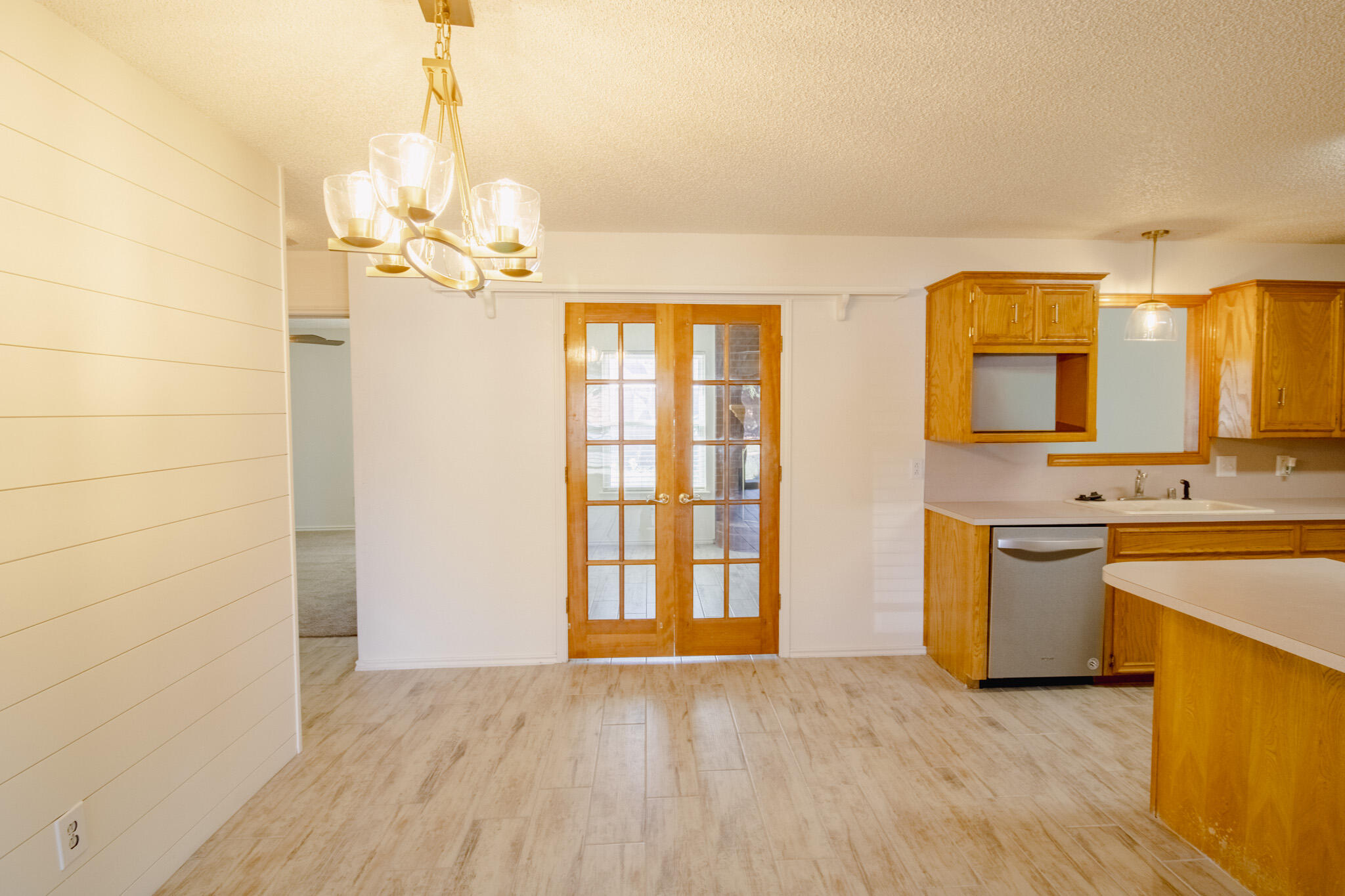 5731 95th Street Lubbock, TX 79424 - Photo 4 of 15 a view of a kitchen with a sink dishwasher a kitchen stove and a wooden cabinets