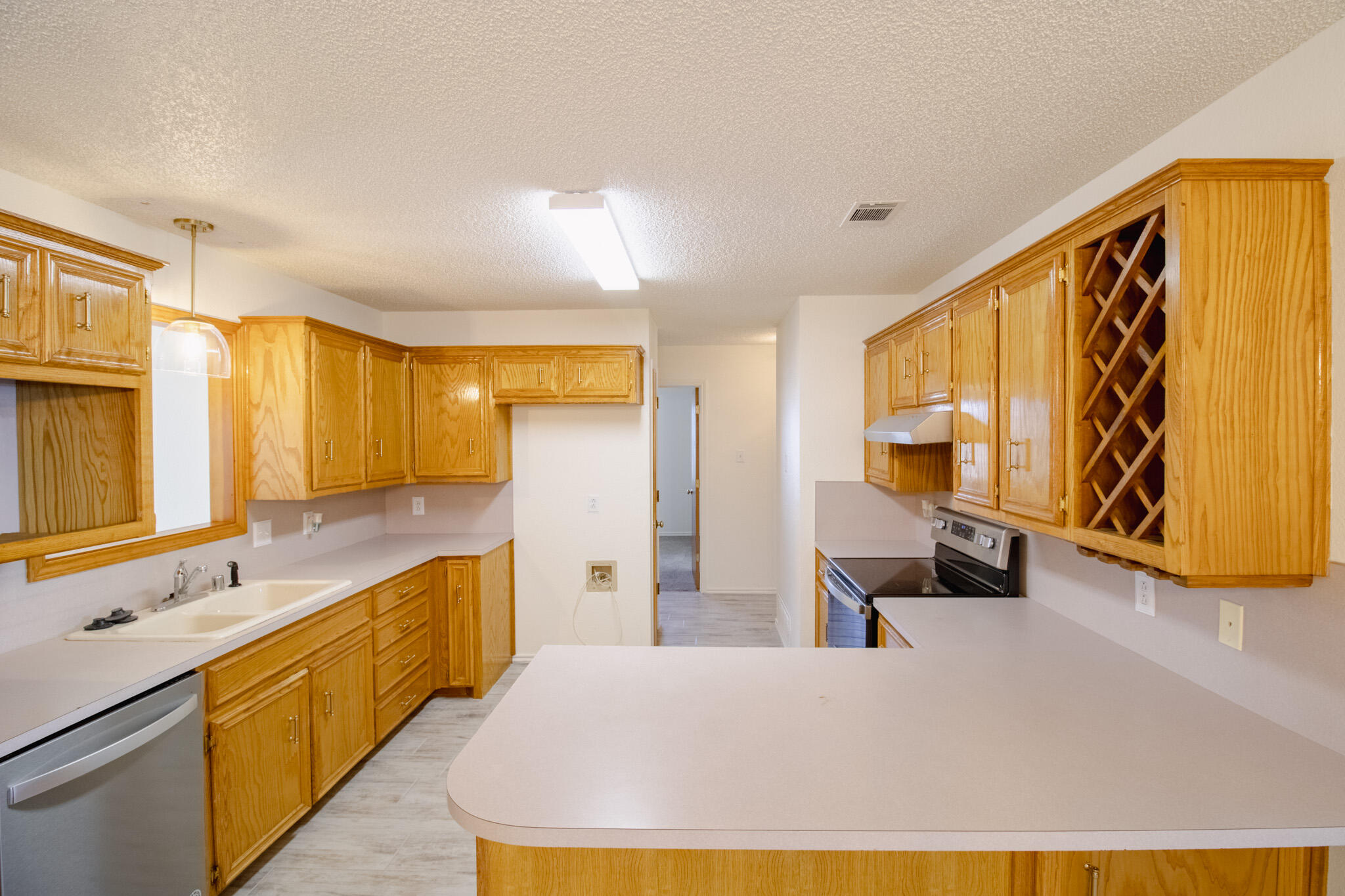5731 95th Street Lubbock, TX 79424 - Photo 6 of 15 a large white kitchen with a large window