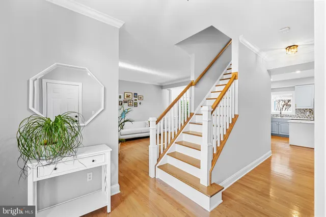 a view of entryway and hall with wooden floor