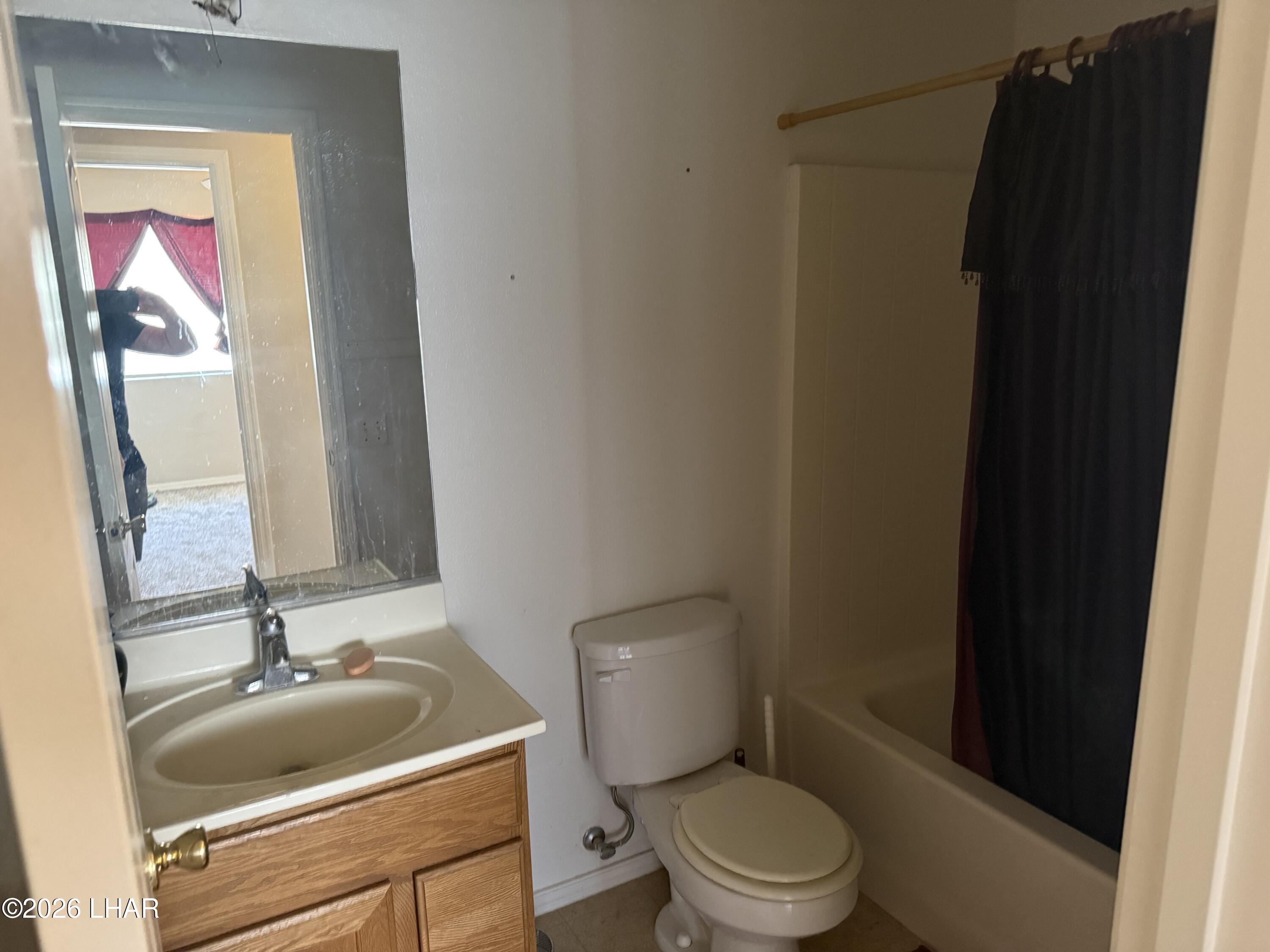 4897 South Rinaldi Drive Fort Mohave, AZ 86426 - Photo 6 of 22 a bathroom with a toilet and a sink