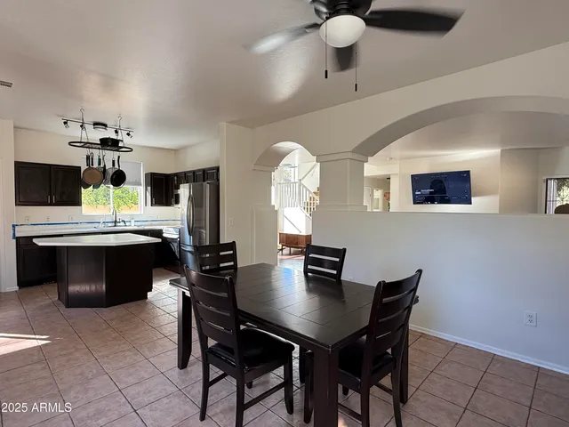 a kitchen with a table chairs and white cabinets