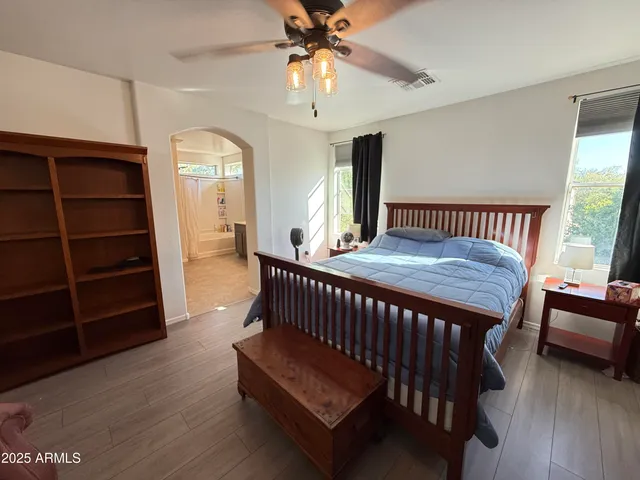 a bedroom with a bed and a chandelier