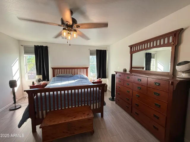 a bedroom with furniture and a chandelier