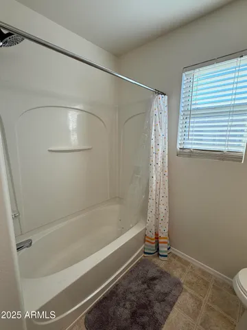 a bedroom with a bed and a ceiling fan