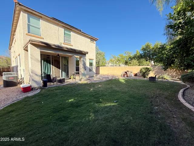 a view of a house with backyard and sitting area