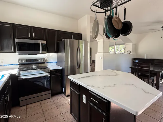 a kitchen with stainless steel appliances a stove a sink and cabinets