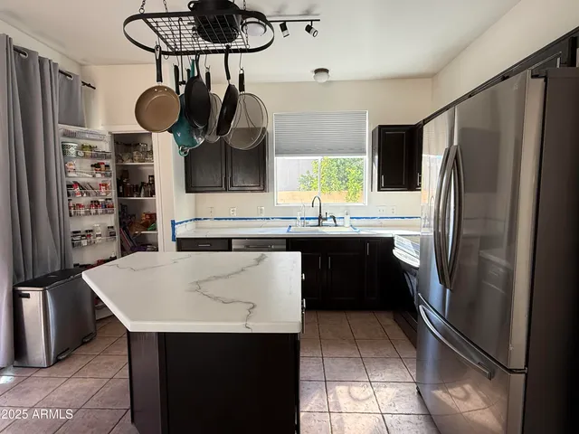 a kitchen with stainless steel appliances a refrigerator and a sink